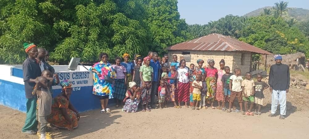 Villagers gathered beside a new well in Sierra Leone